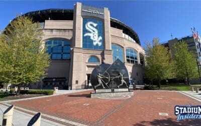 The exterior of Guaranteed Rate Field with a statue of two baseball players in the foreground