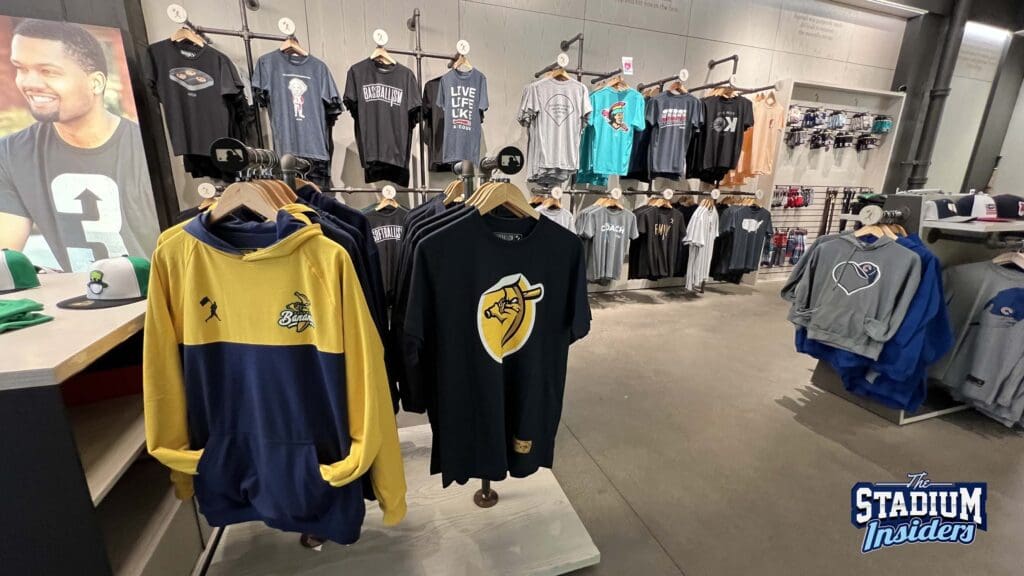 Merchandise hangs on walls and clothing racks inside Baseballism, Chicago