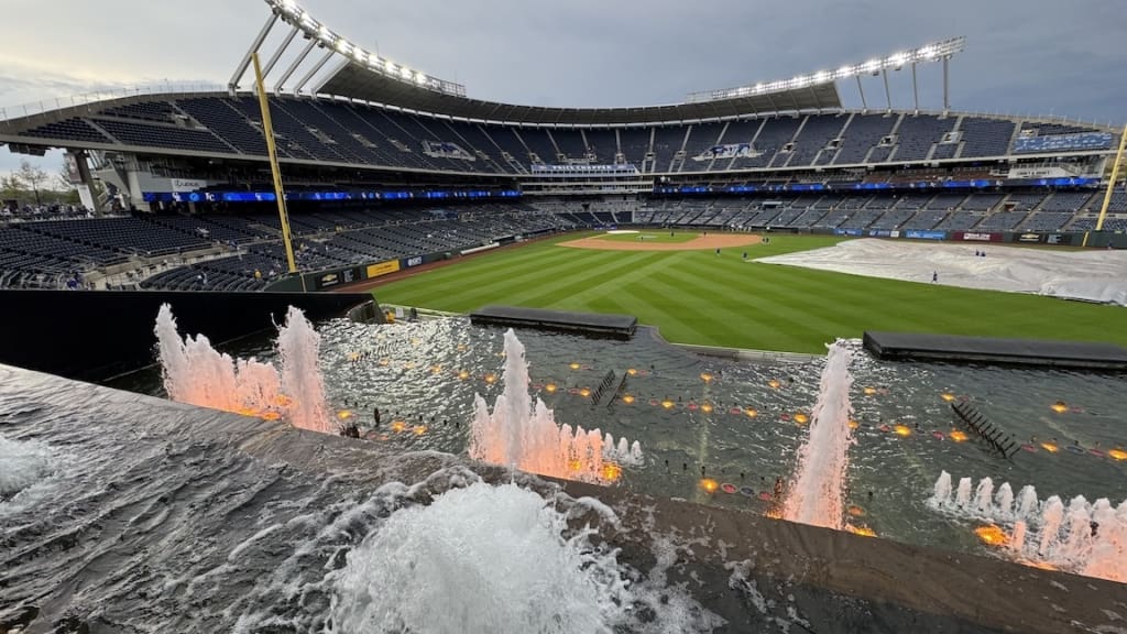 Kauffman Stadium at night with a fountain in the foreground